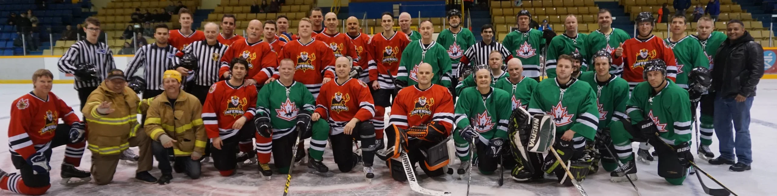 Firefighters and RCMP players together on the ice after the Guns & Hoses charity hockey game
