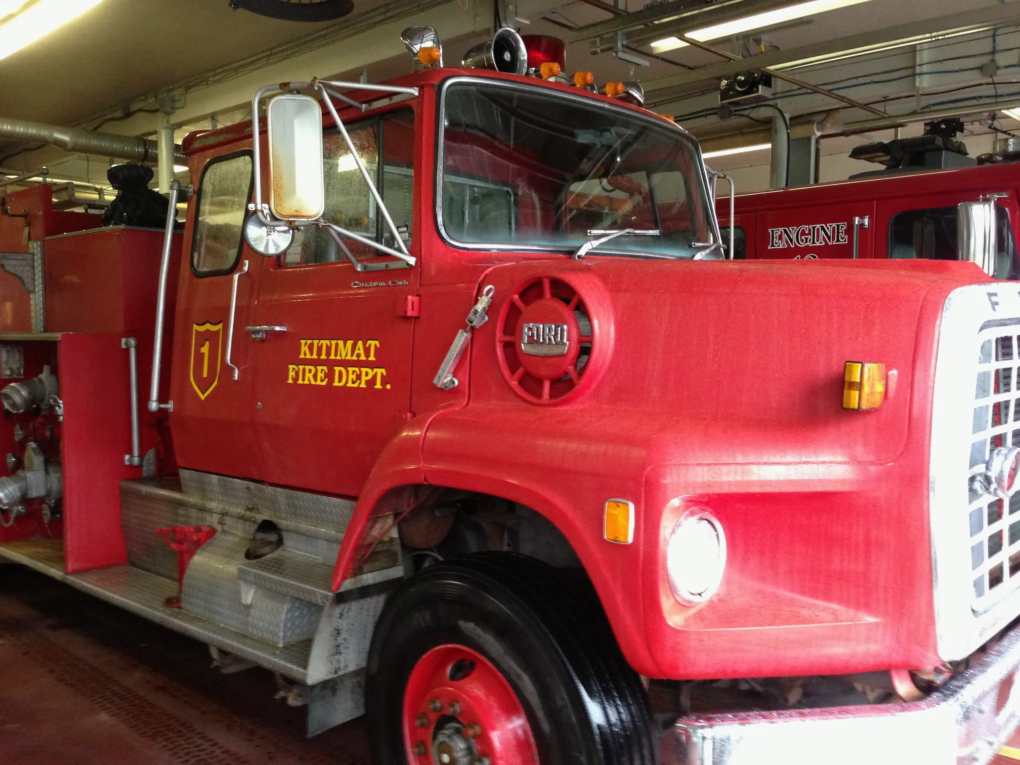 A historic red Kitimat Fire Department engine inside the station